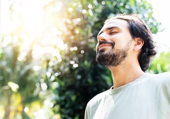 A man taking a meditative walk.
