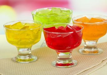 Colorful, synthetically-colored jelly cubes in bowls.