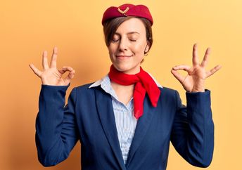 A flight attendant leading plane yoga.