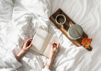 A person journals during the daytime.