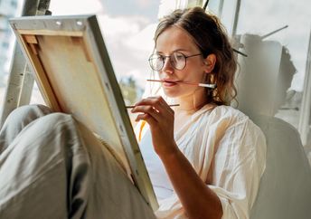 Young mom taking some me time to paint.