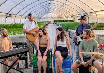 Hashayara plays music in a greenhouse.