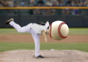 Baseball pitcher throwing to a batter.