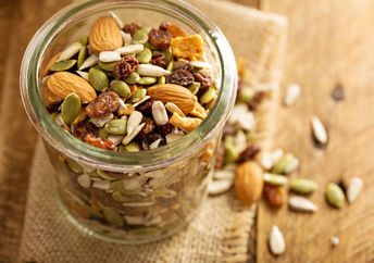 A jar filled with seeds and nuts.