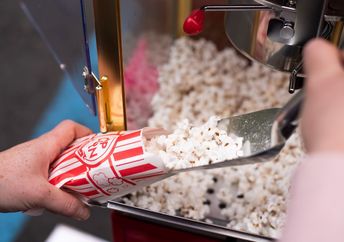Old fashioned popcorn makers are a hit at a party.