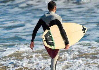 Surfer wearing a wetsuit.