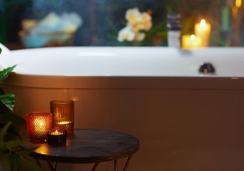 A bathroom with warm and dim candles.