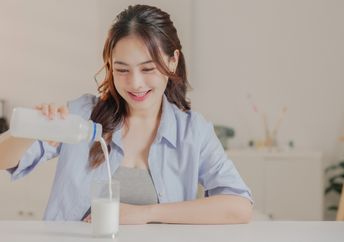 Enjoying a glass of vegan dairy-free milk.