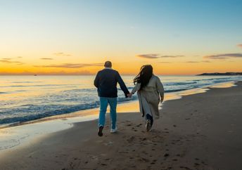 Strolling by the shore at twilight.