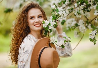 A woman in a blooming garden.