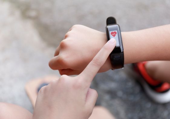 A girl touches a smartwatch.