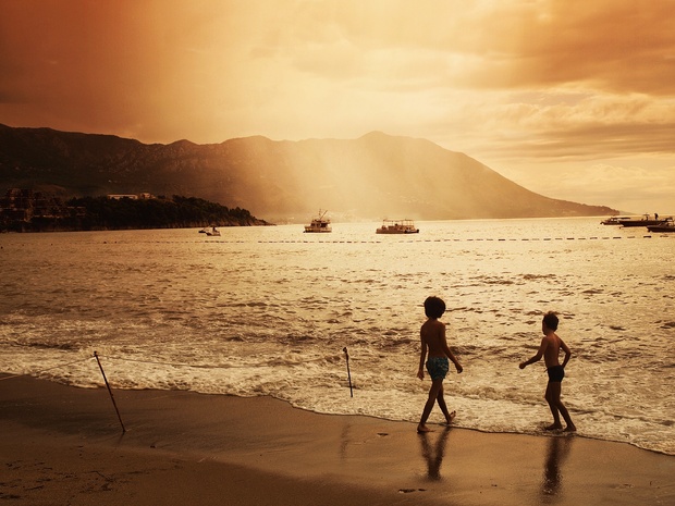 Happy healthy children playing on the beach