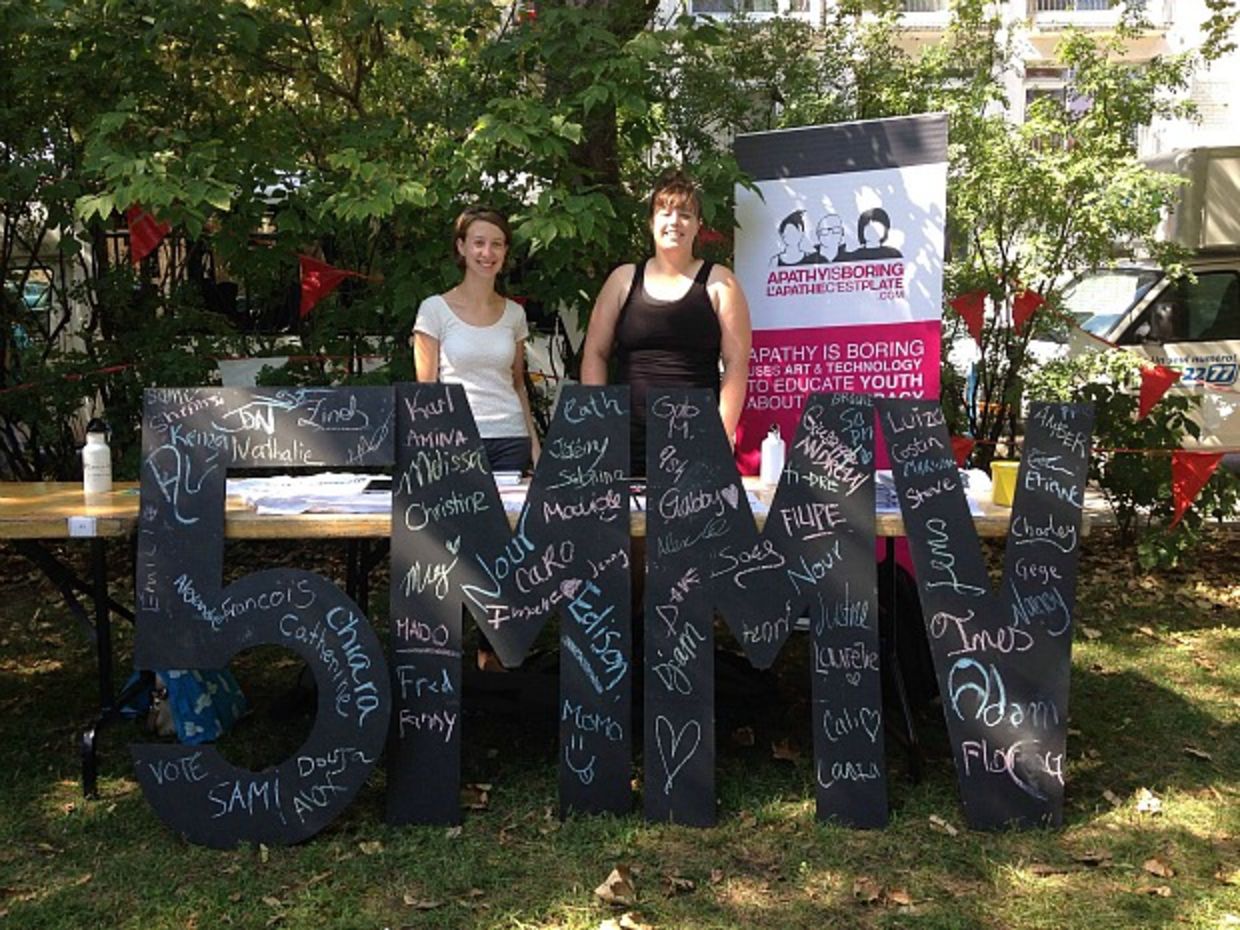 Volunteers hold sign to get Canadian youth to vote