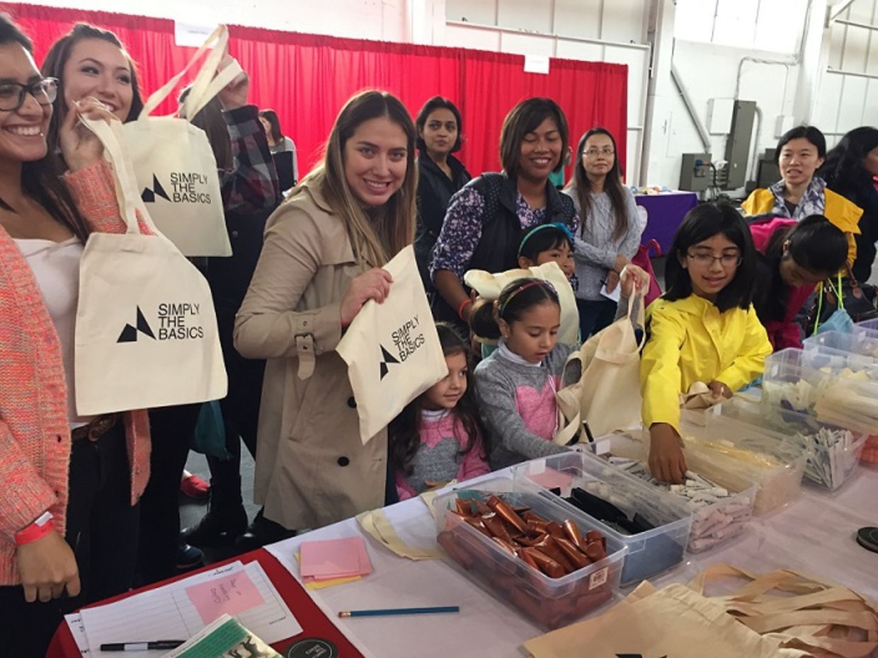 Simply the Basics volunteers help package hygiene kits. (Simply the Basics)