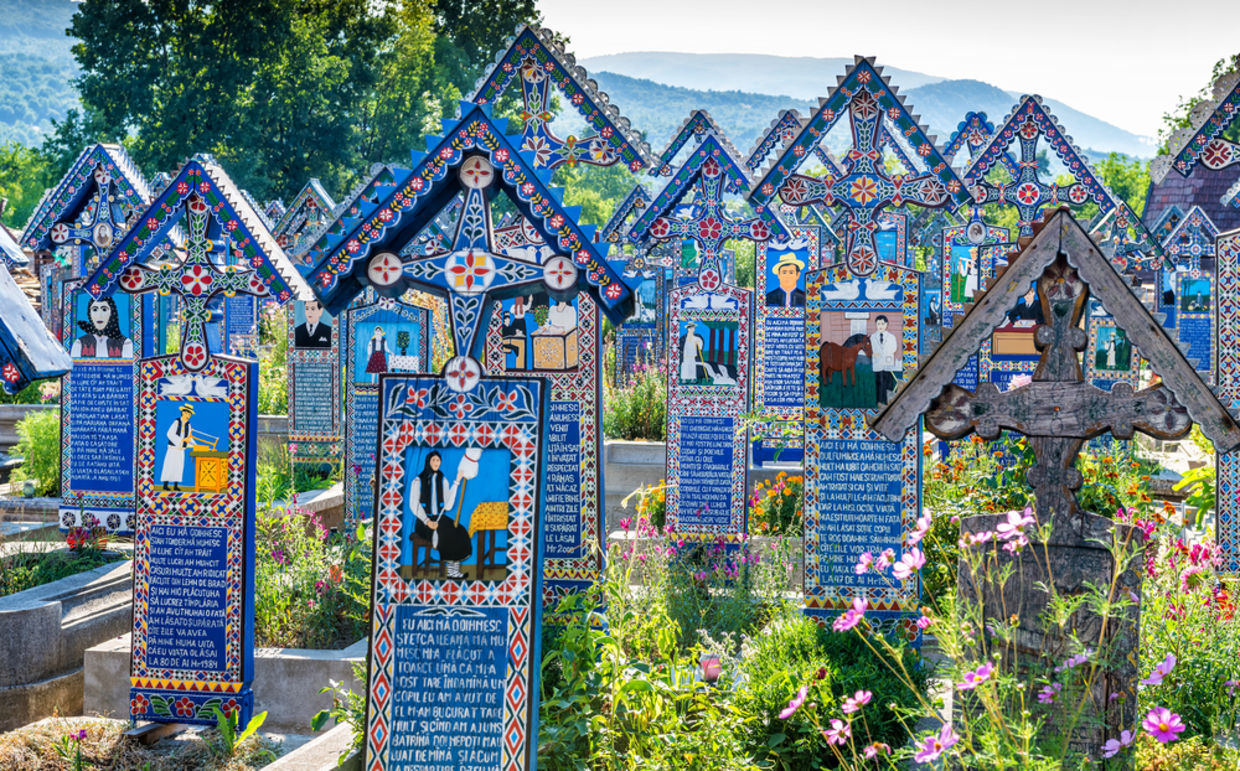 Painted wooden crosses in the famous Merry Cemetery in Maramures, Romania. (Danilovski / Shutterstock.com)