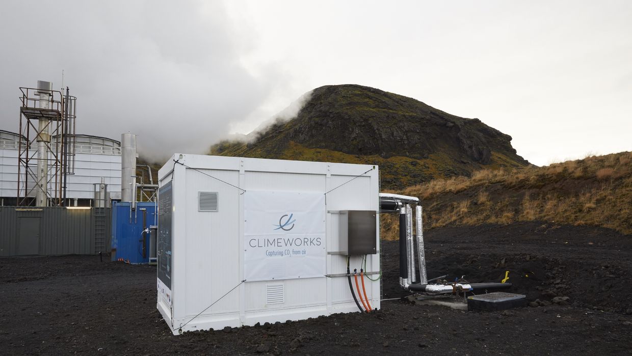 Direct air capture unit along with the cooling towers of the geothermal power plant in Hellisheidi, Iceland.