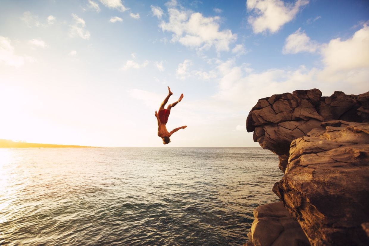 Cliff Jumping into the Ocean at Sunset