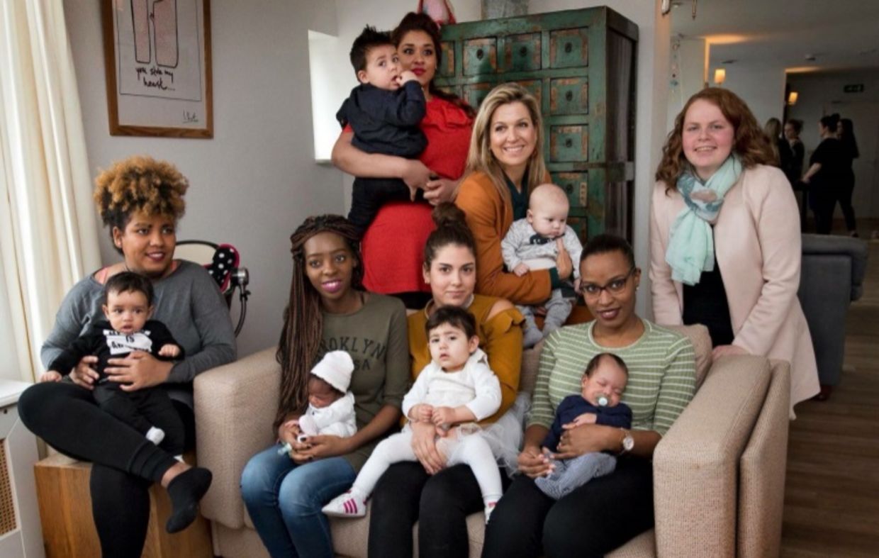 Queen Máxima of the Netherlands sits with young mothers at the Baby House in Dordrecht