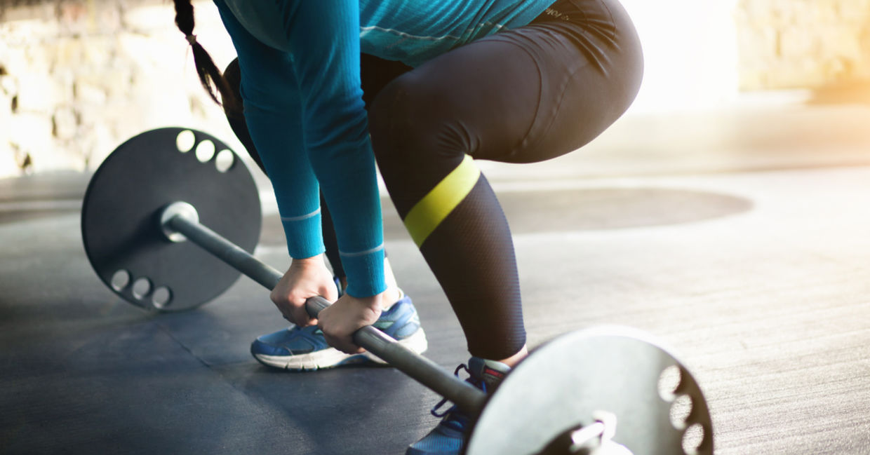Woman does push ups on sand
