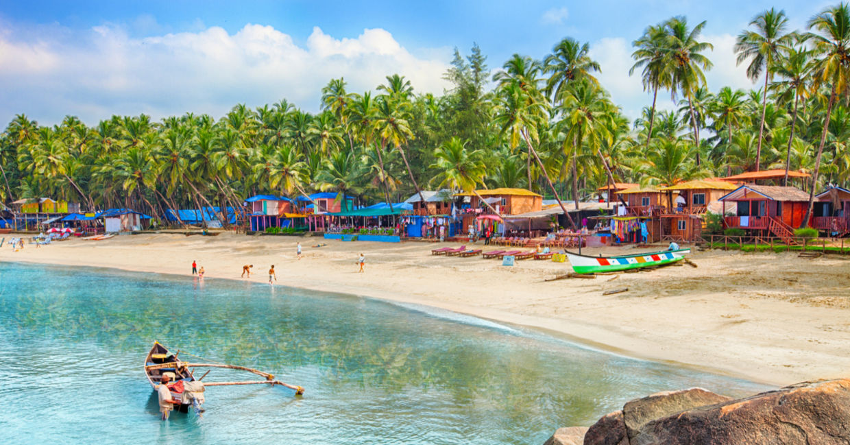 Tropical beach in Goa on a background of palm trees