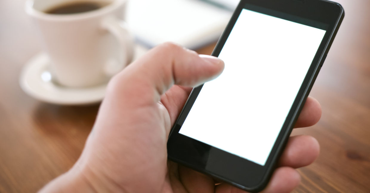 A person holding using a smartphone with one hand