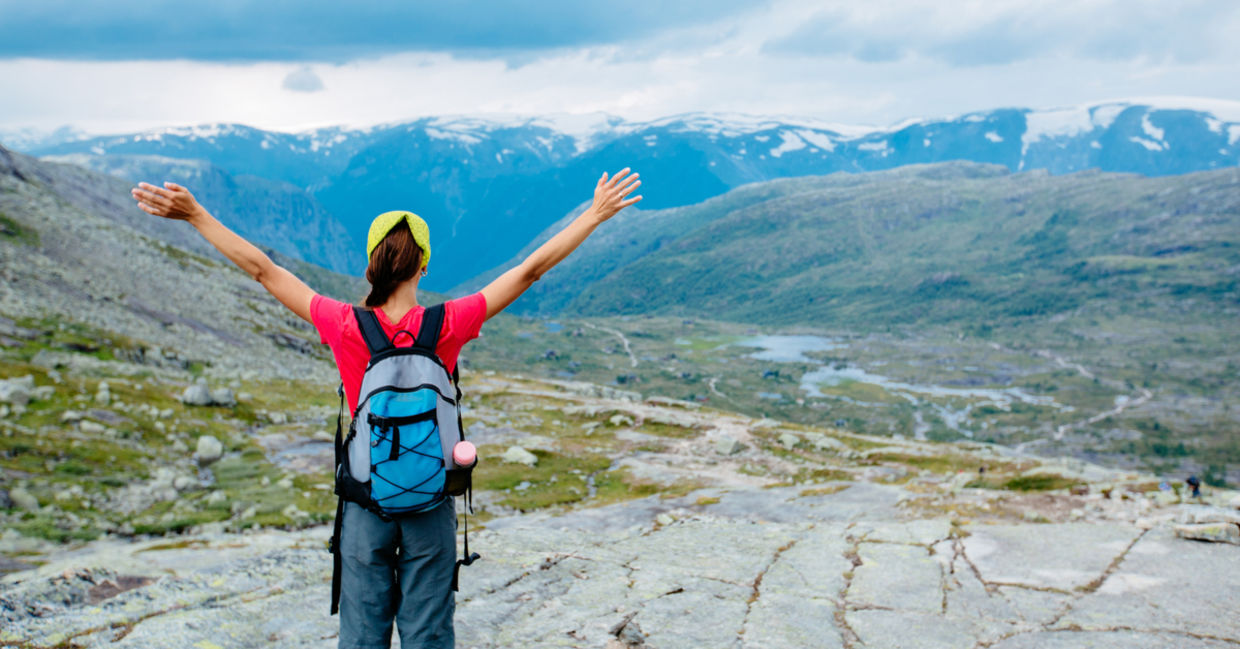 Woman stretching arms hiking
