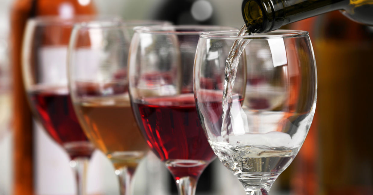Wine being poured into wine glasses
