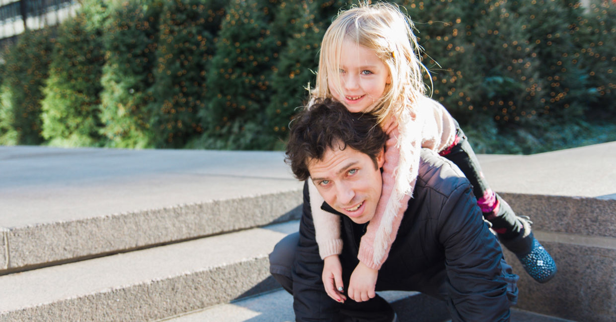 Father and small daughter walk in the park