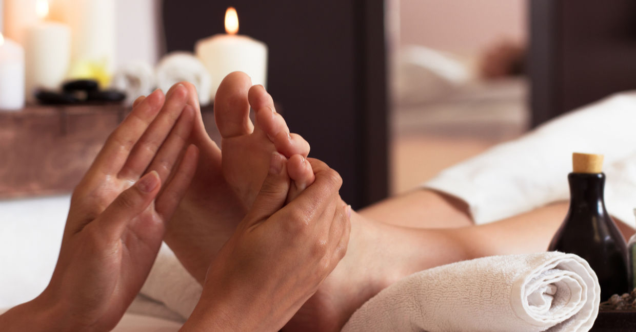 Massage of human foot in spa salon