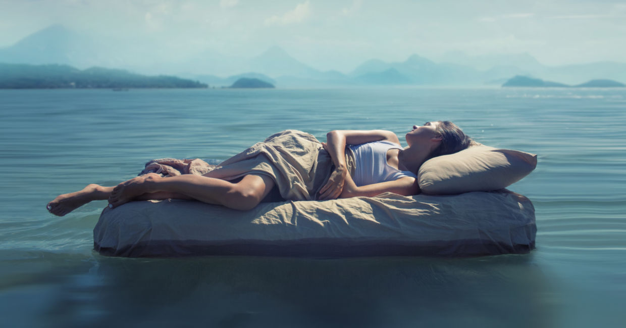 A woman sleeps in a dark room