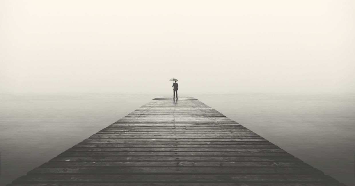business man with umbrella looking at the horizon