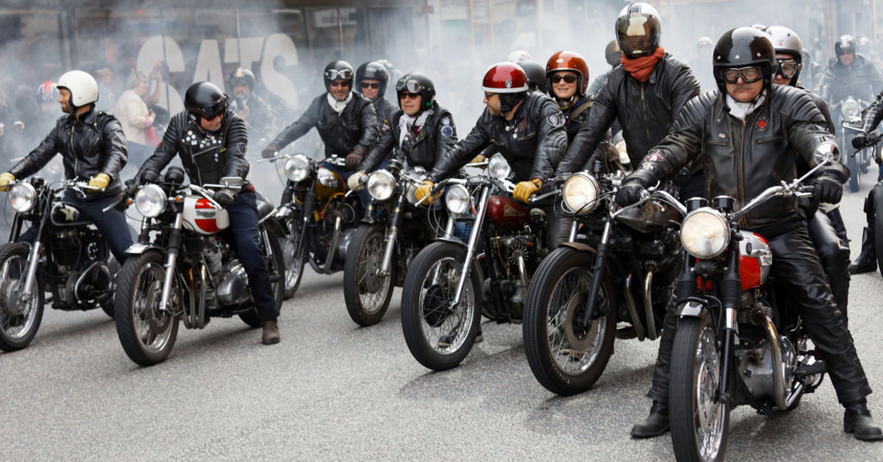 Members of motorcycle clubs ride together in large groups showing off their bikes