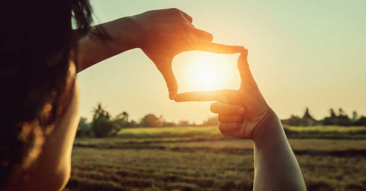 Hands framing the sun
