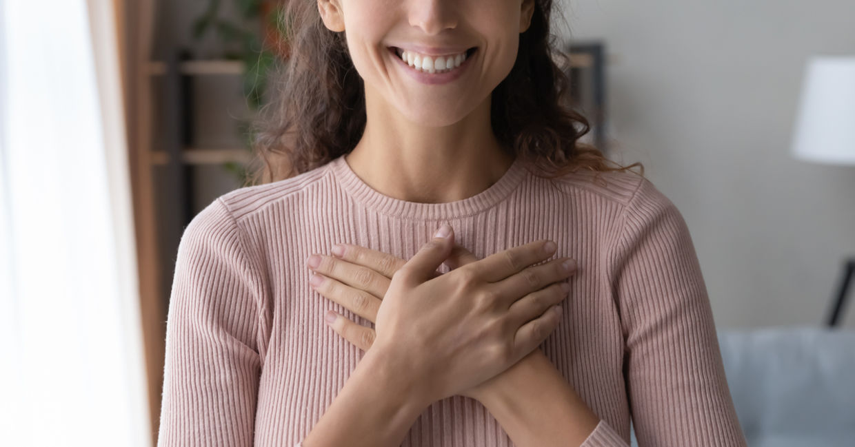 A woman smiles after receiving a compliment.