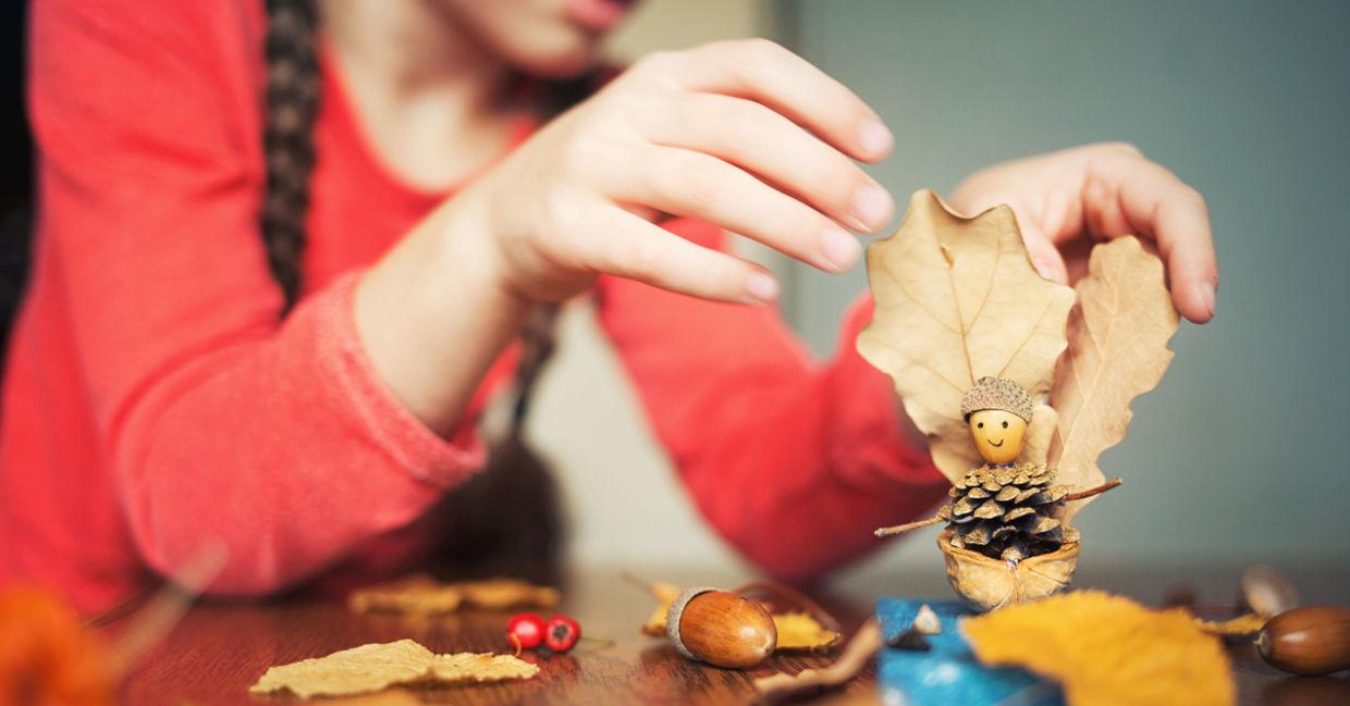 Child painting pinecones