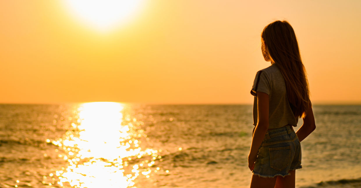 Girl at sunset near water