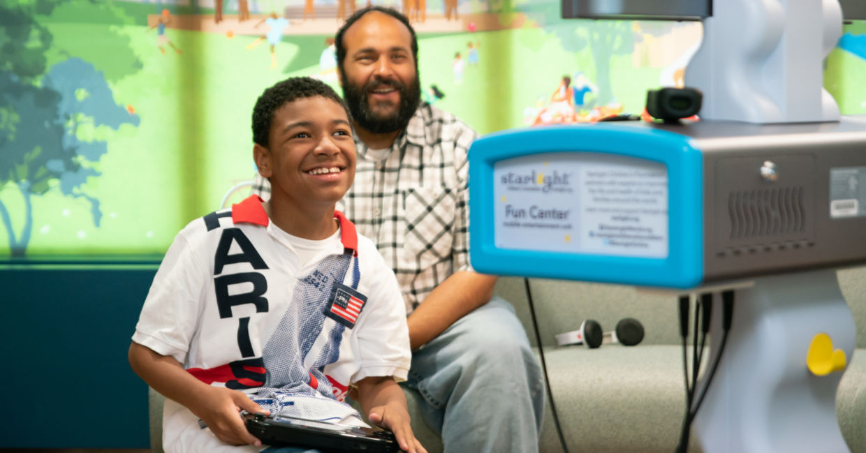 A boy in the hospital plays Nintendo.