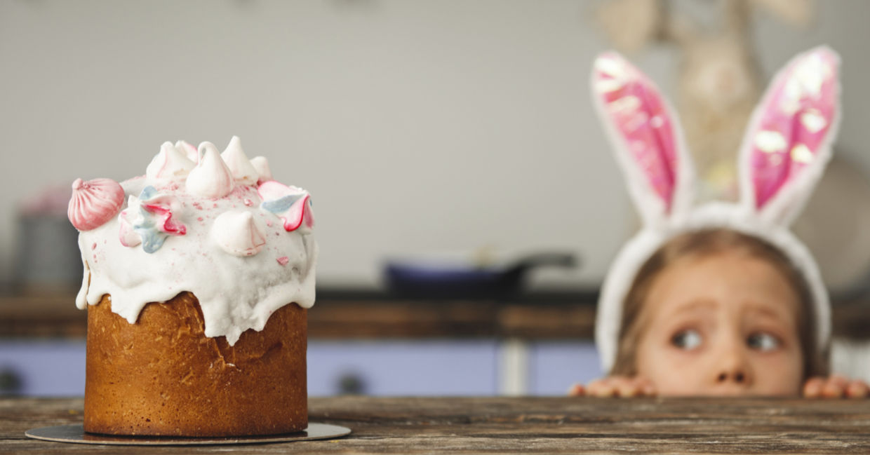Little girl staring longingly at an Easter treat!