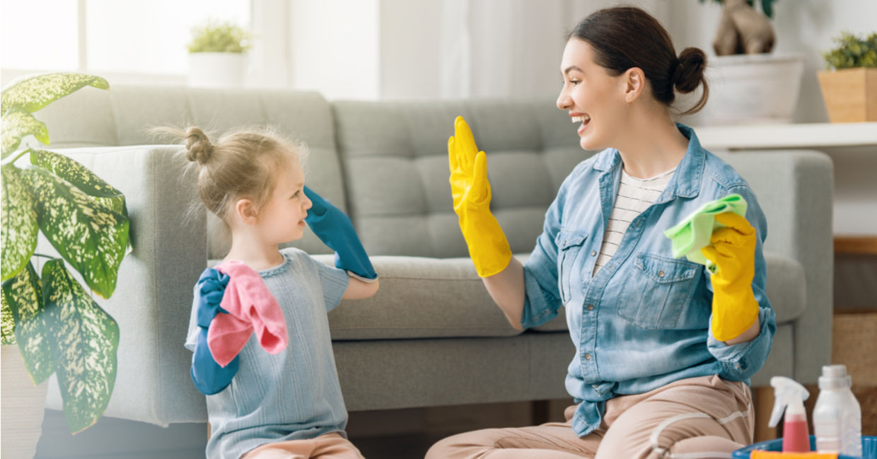Mom and daughter having fun cleaning the house