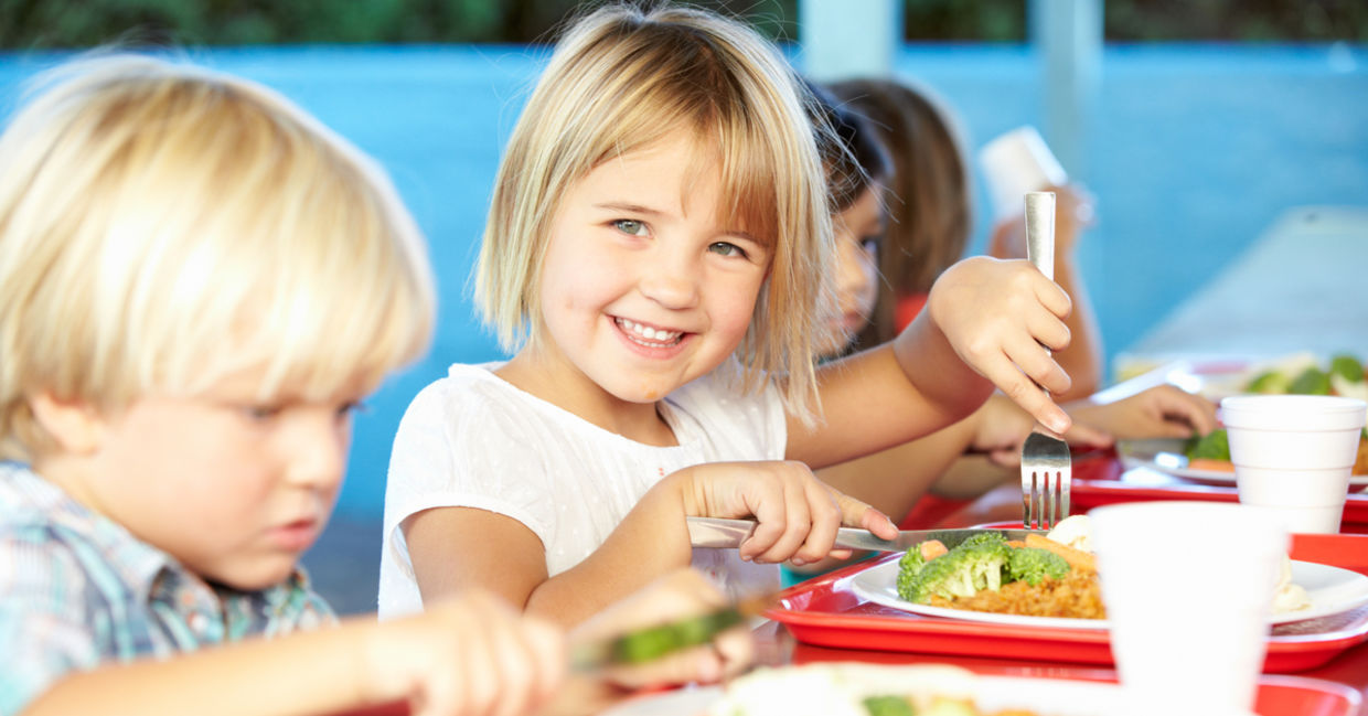 Little girl eating a healthy school lunch