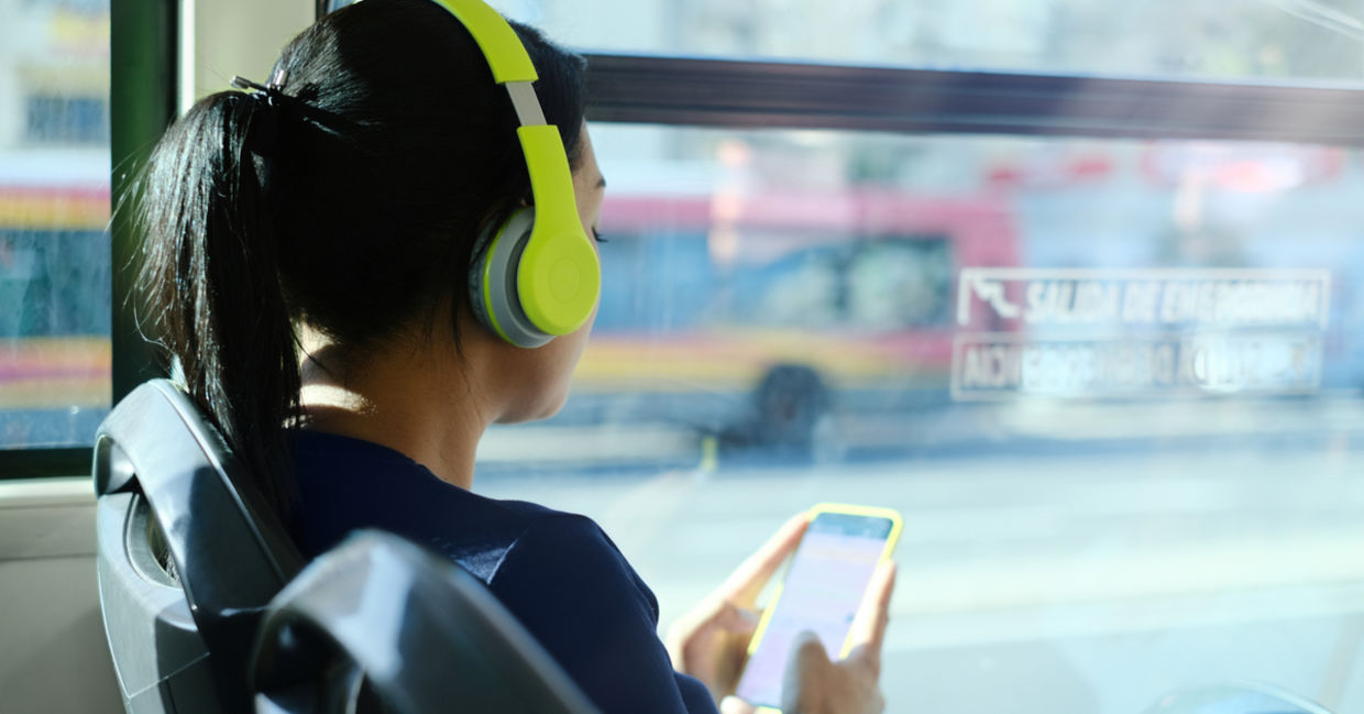 Woman listening to podcast on bus