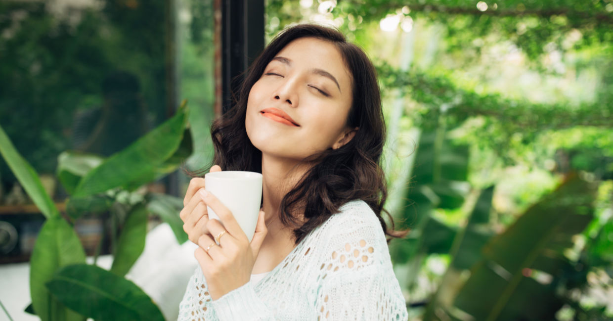 A woman enjoys her morning coffee