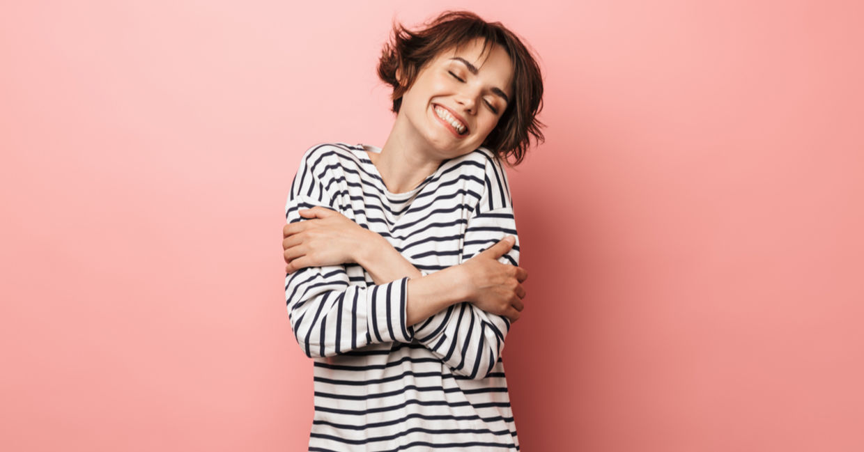 Woman gives herself a hug