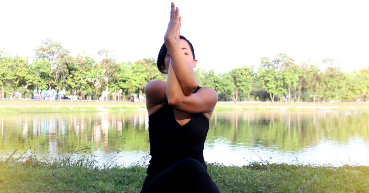 Woman in eagle yoga pose.