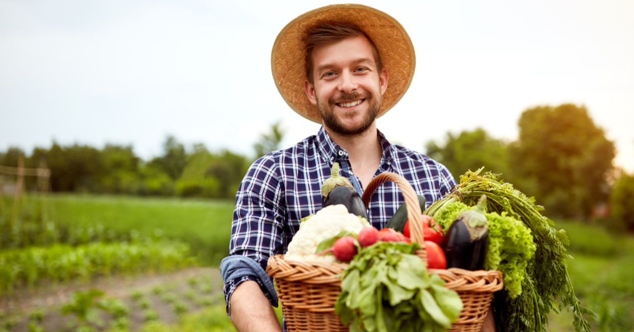 Young farmer holding crops