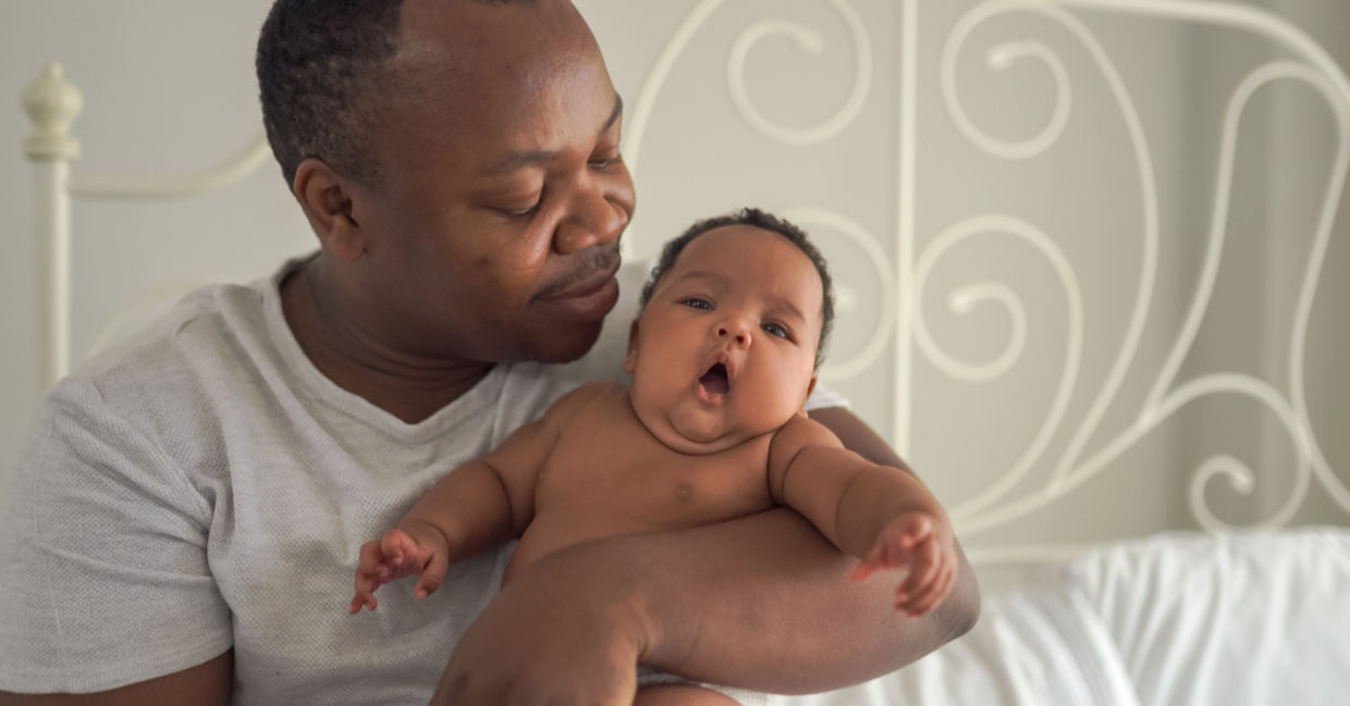 A father hugs his baby.