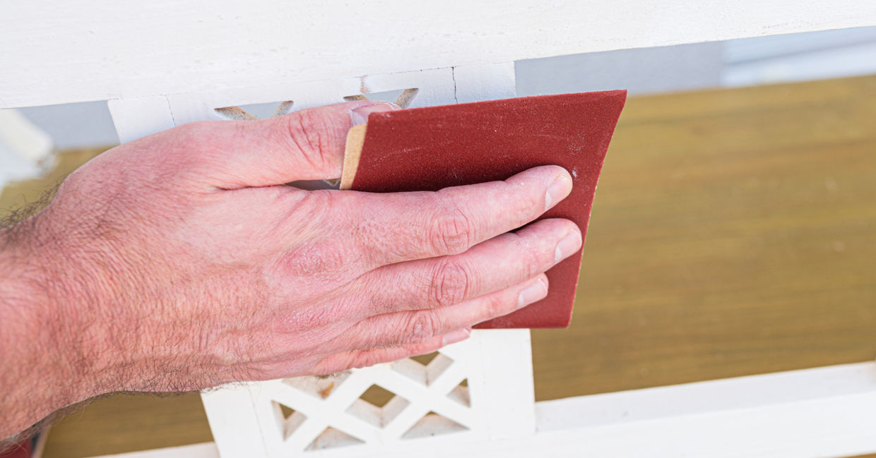 Man sanding a piece of furniture.