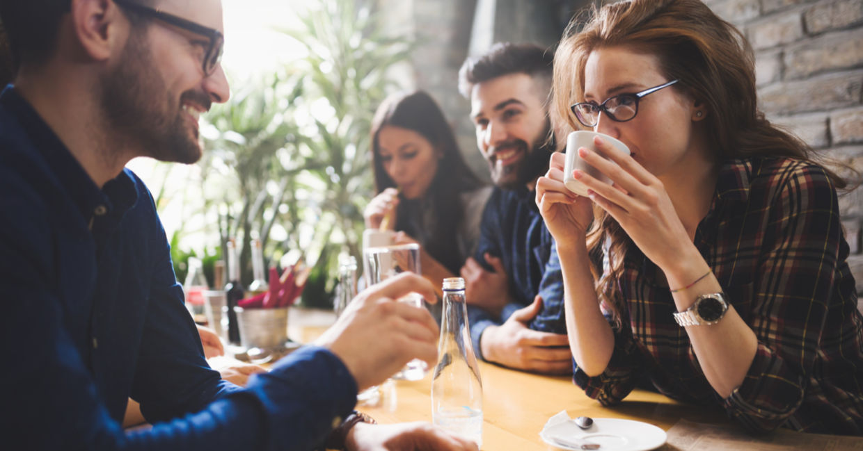 Friends sipping coffee and chatting after a meal.
