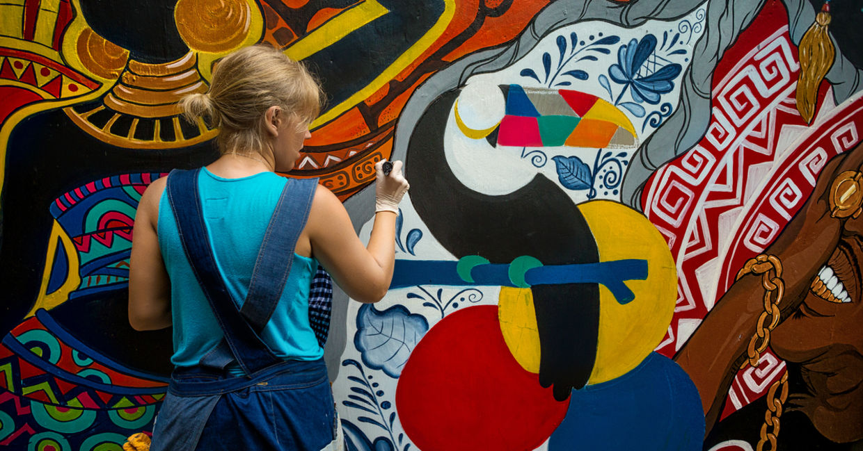 Woman painting street art.