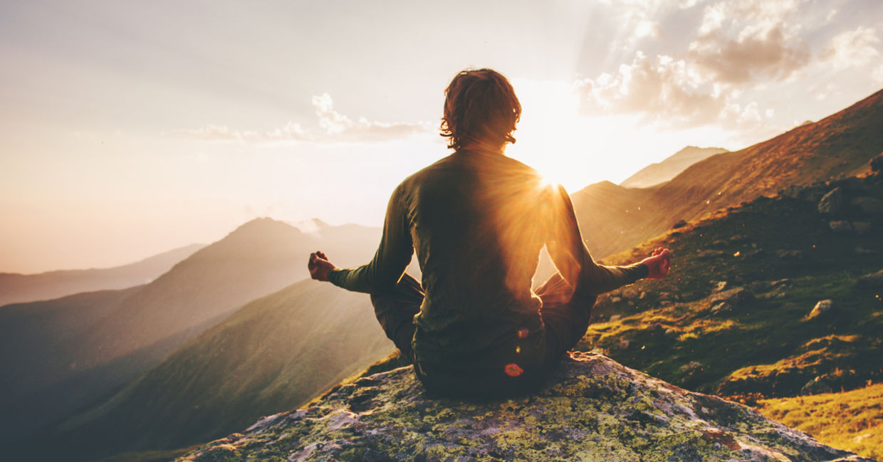 Man meditating outdoors.